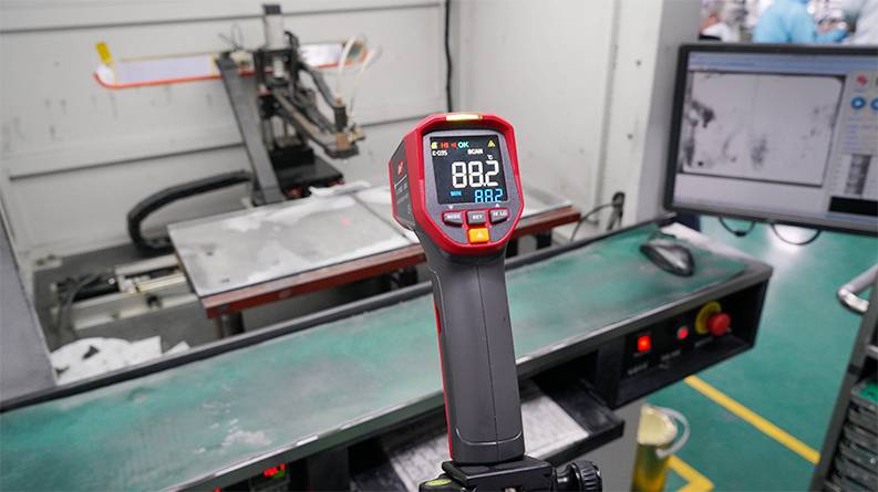 UNI-T UT305S infrared thermometer in an industrial application for non-contact temperature measurement in production.